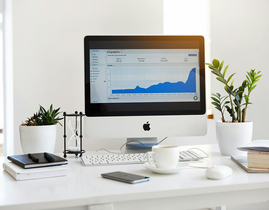 Desk with laptop showing performance analytics
