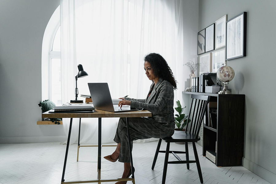 Professional working on a laptop in a bright office